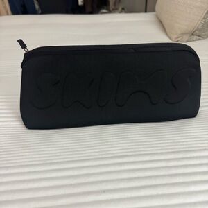 SKIMS black neoprene pouch